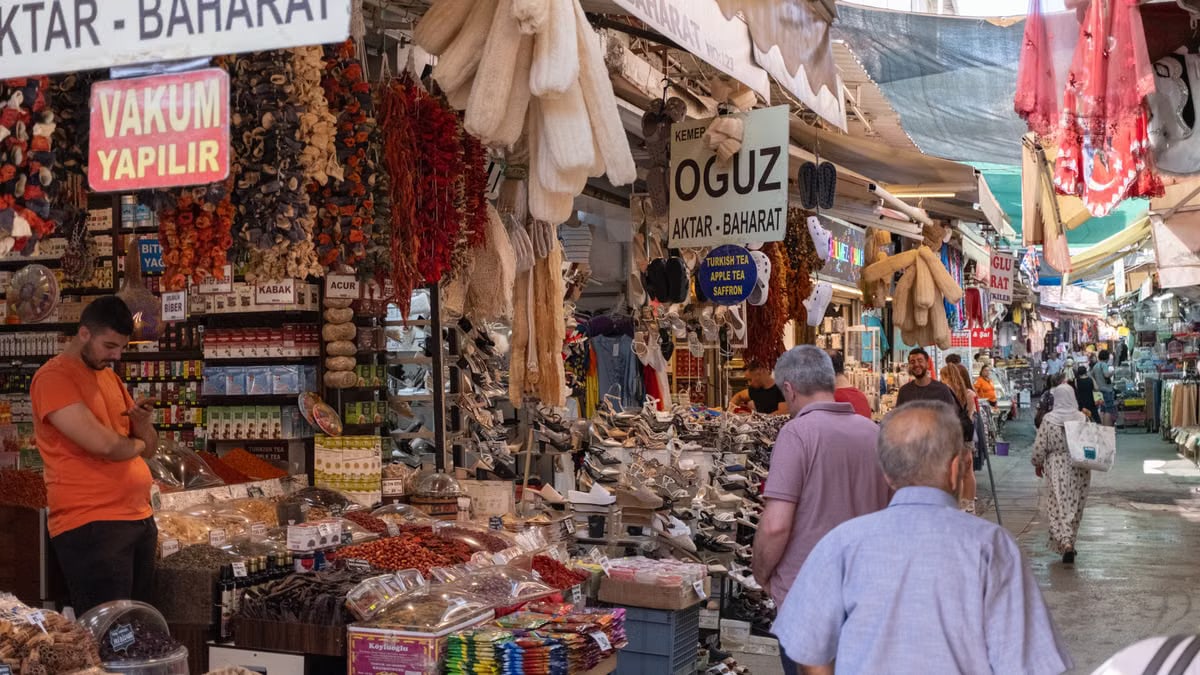Vibrant market scene in Izmir, Turkey showcasing stalls with spices and shoppers.
